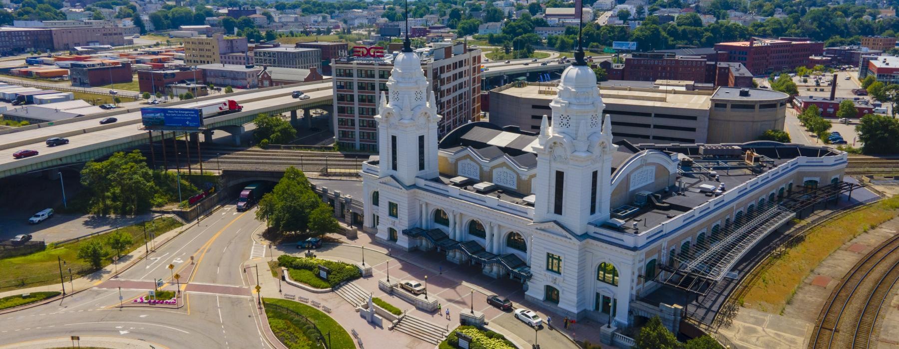 a large white building with a parking lot in front of it
